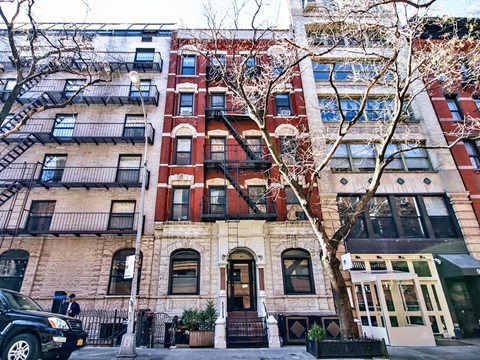 a view of a building with a tree in front of it