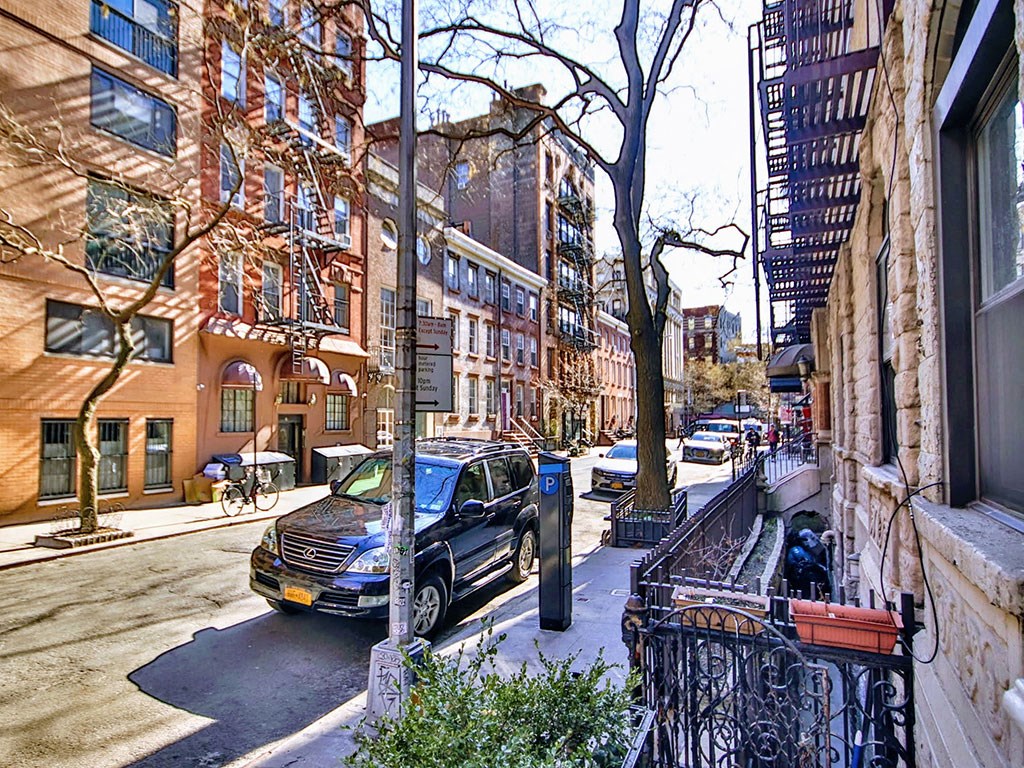 a street view of a city street with cars and buildings