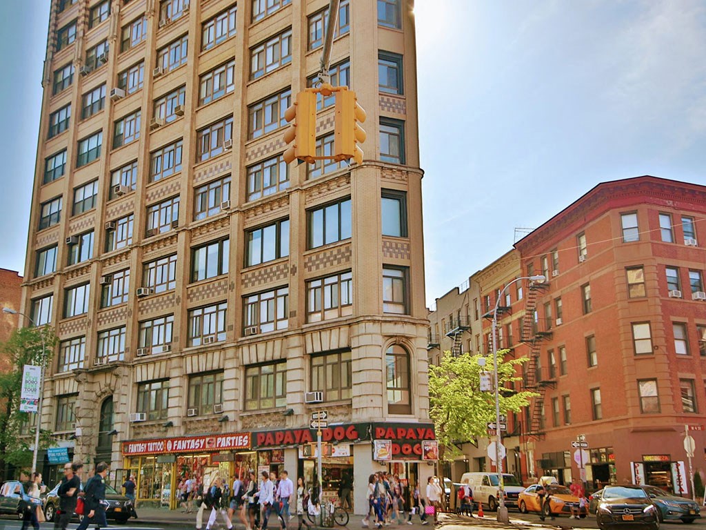a large building on the corner of a busy city street