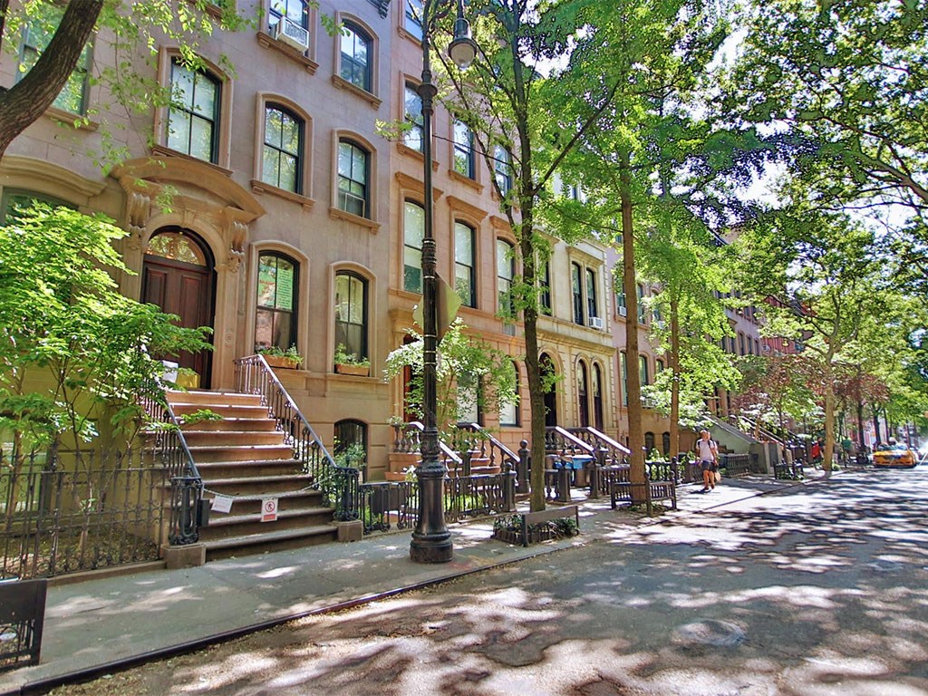 a building on a city street with trees