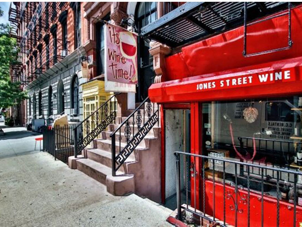a red wine store on the side of a city street