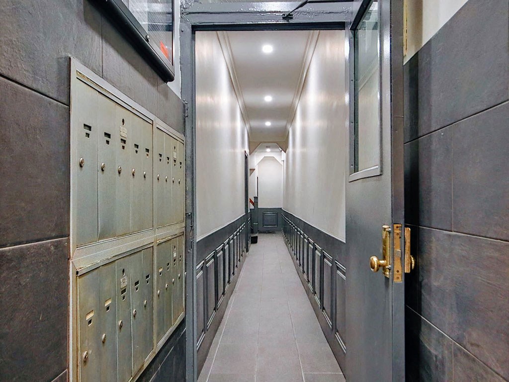 a long hallway with rows of lockers and doors