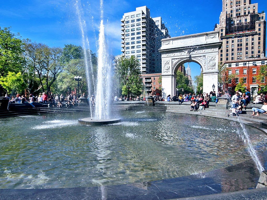 a fountain in a park in a city
