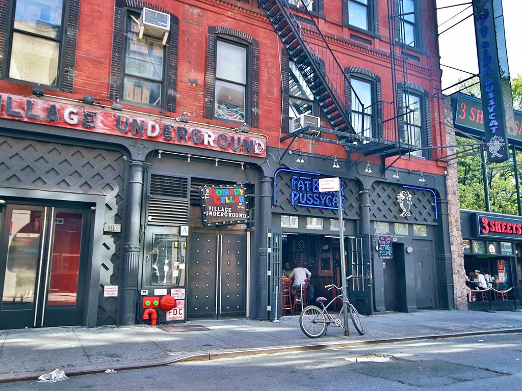 a bike parked in front of a building on a street