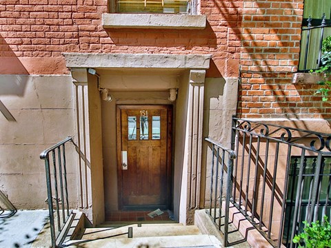 the front door of an old brick house with a wooden door