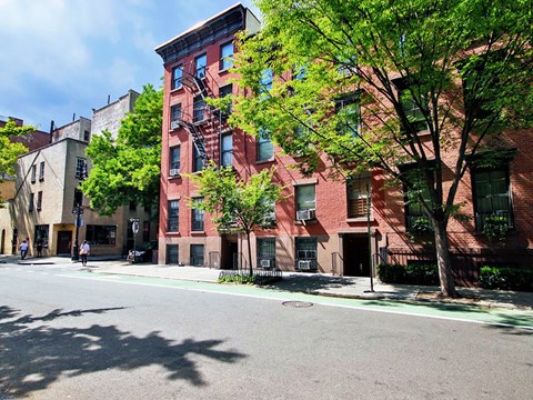 a red brick apartment building on a city street