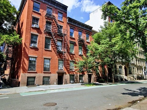 a red brick apartment building on a city street
