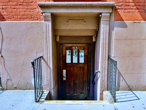a wooden door in front of a brick building