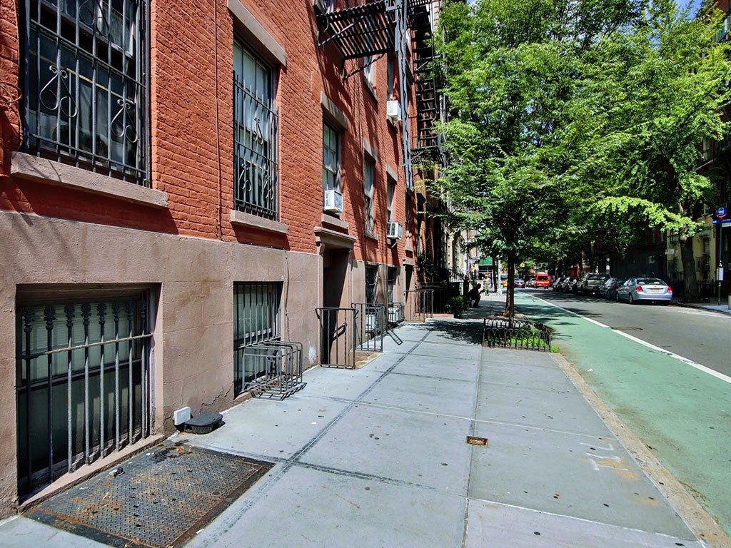 a city street with brick buildings and trees