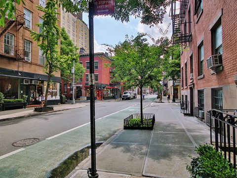 a city street with tall buildings and trees