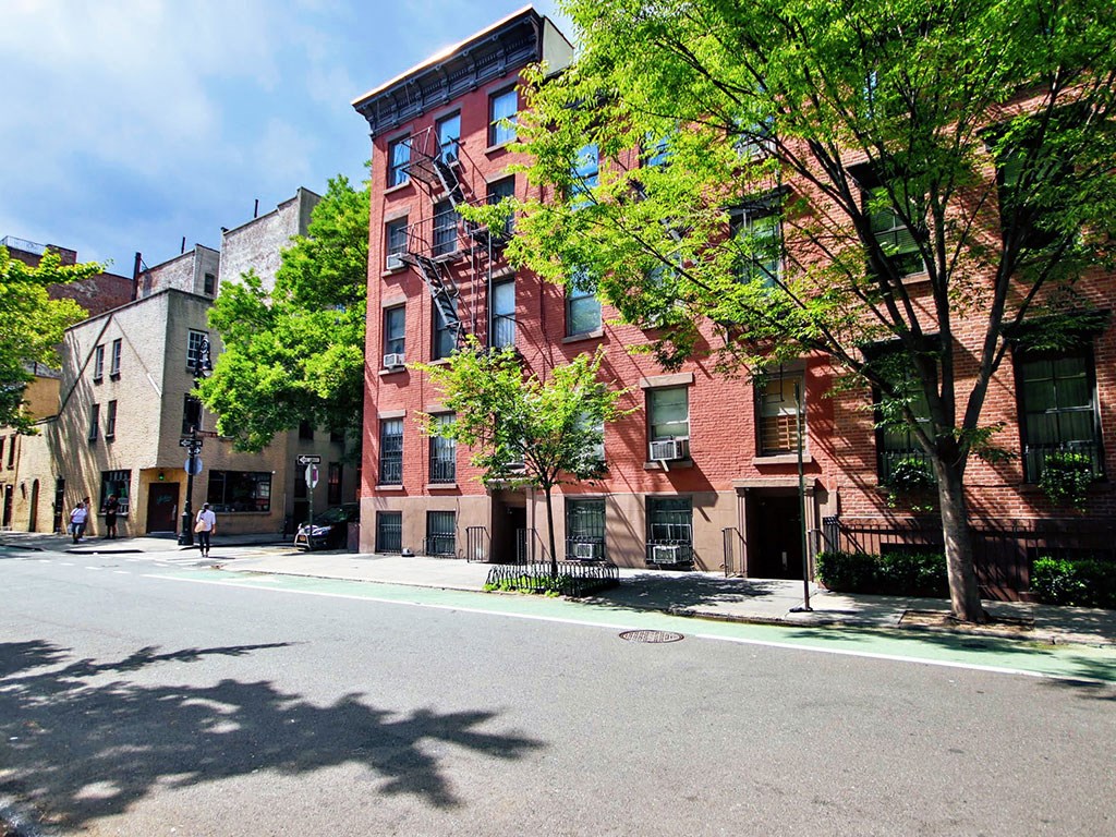 a red brick apartment building on a city street