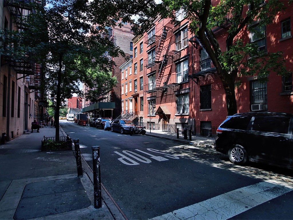 a city street with cars parked on the side of it