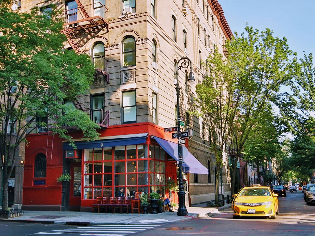 a yellow taxi parked in front of a building on a city street
