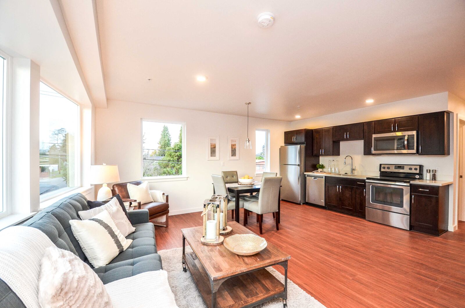 a living room with a couch and a table and a kitchen