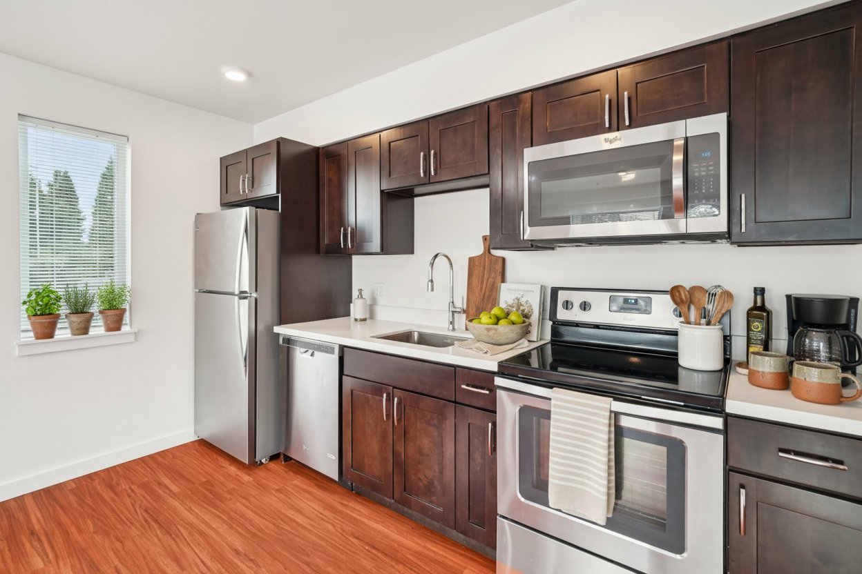 A kitchen with dark wood cabinets and stainless steel appliances.