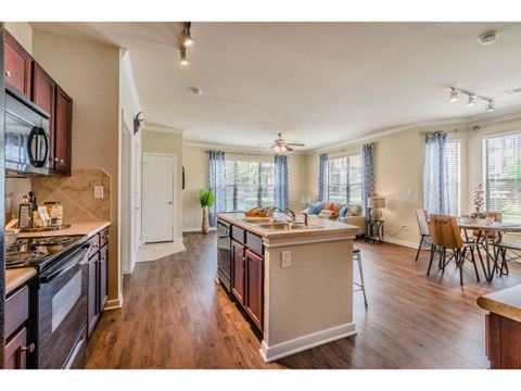a kitchen with an island and a dining room with a table