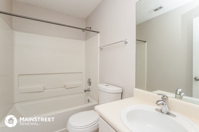 a bathroom with a sink and a toilet and a bath tub