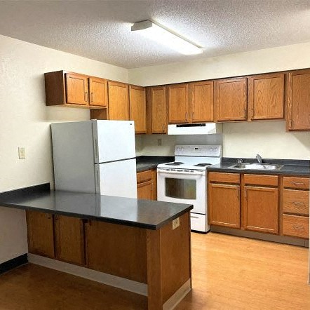 a kitchen with a stove and a refrigerator