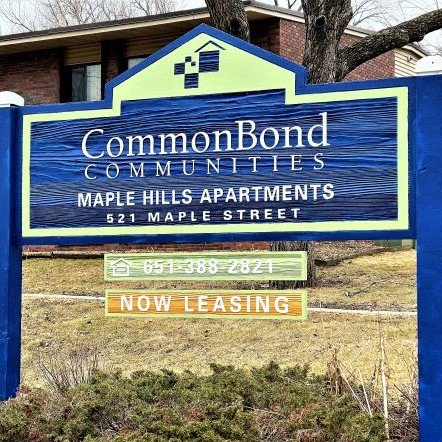 a blue and white sign in front of a building
