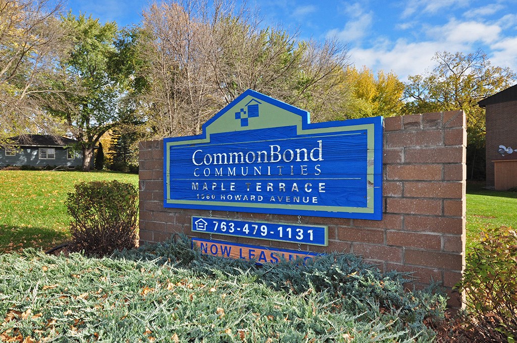 a sign in front of a brick building