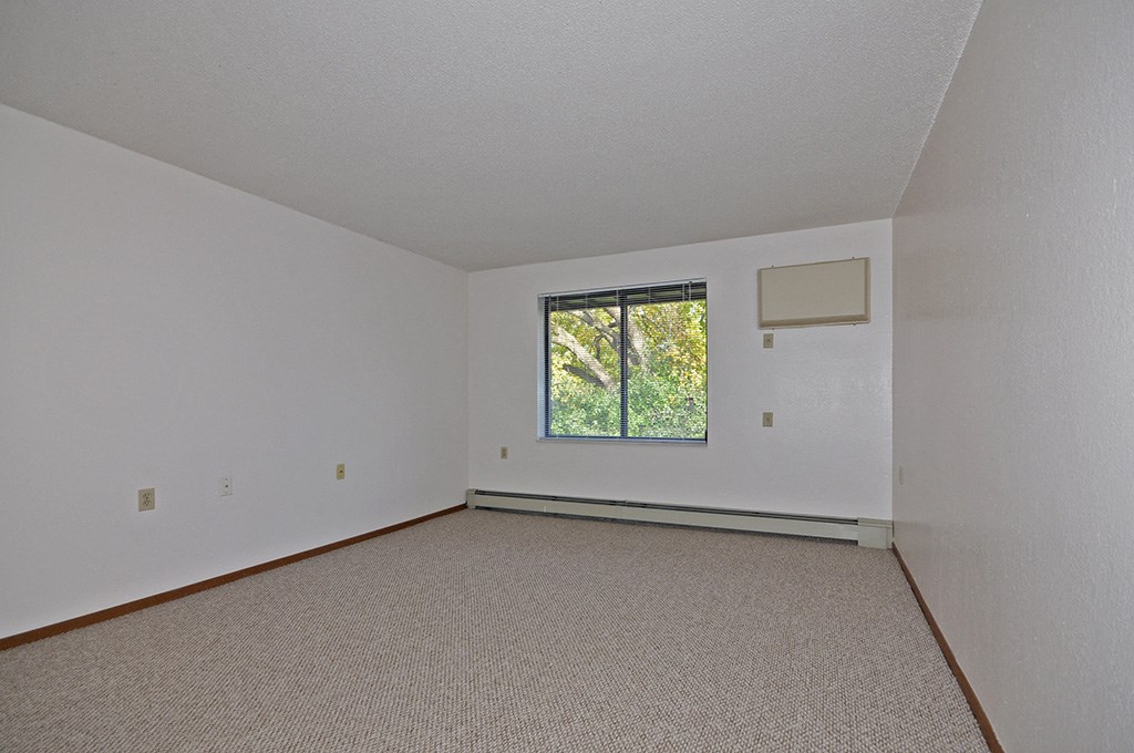 the living room of an empty house with a window