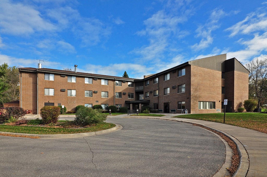 a large brick building with a roundabout in front of it