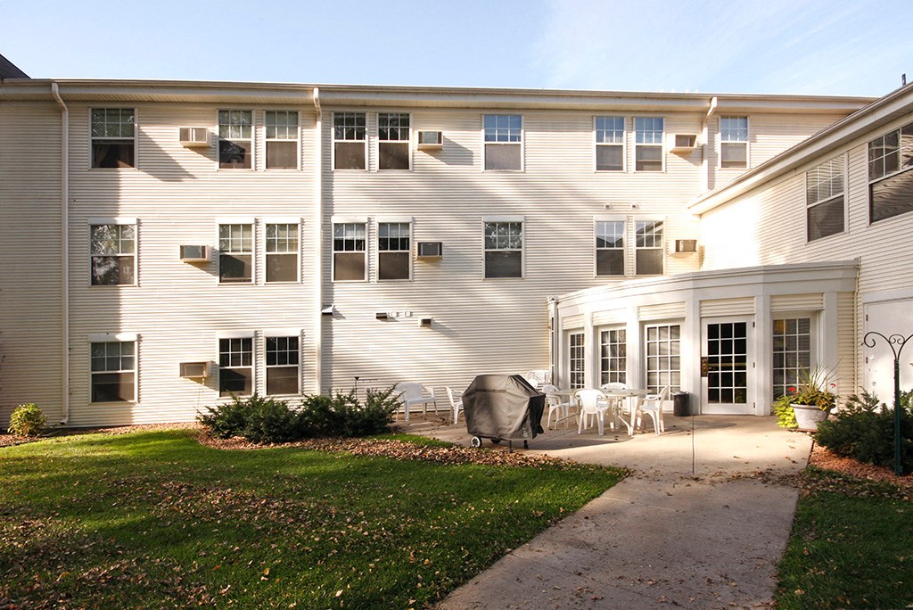 a large white house with a sidewalk in front of it