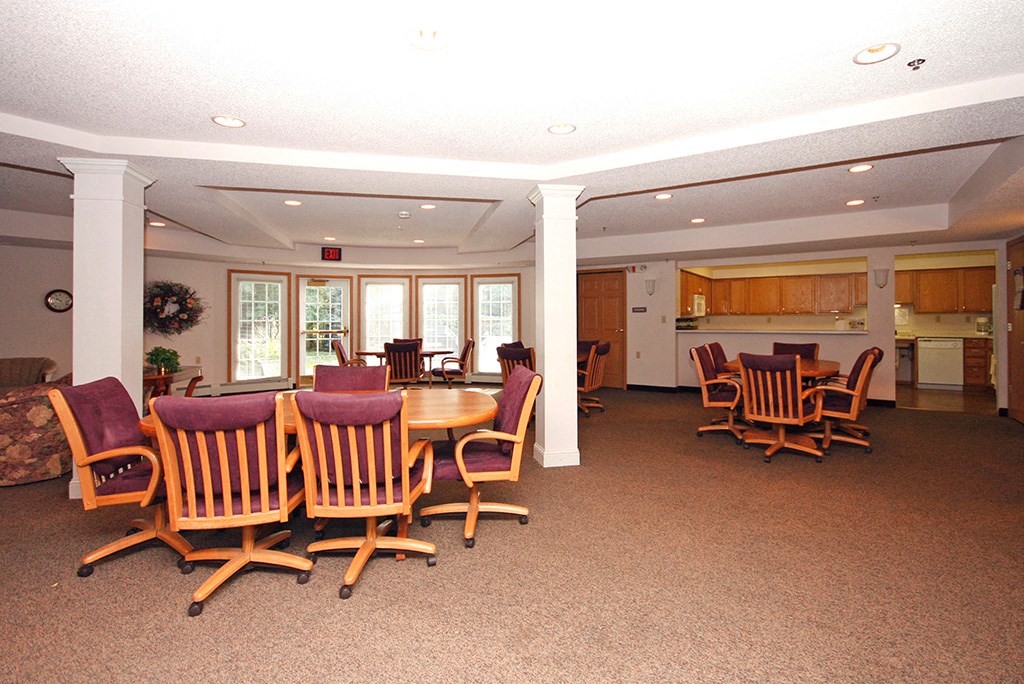 a dining room with chairs and a table in the center