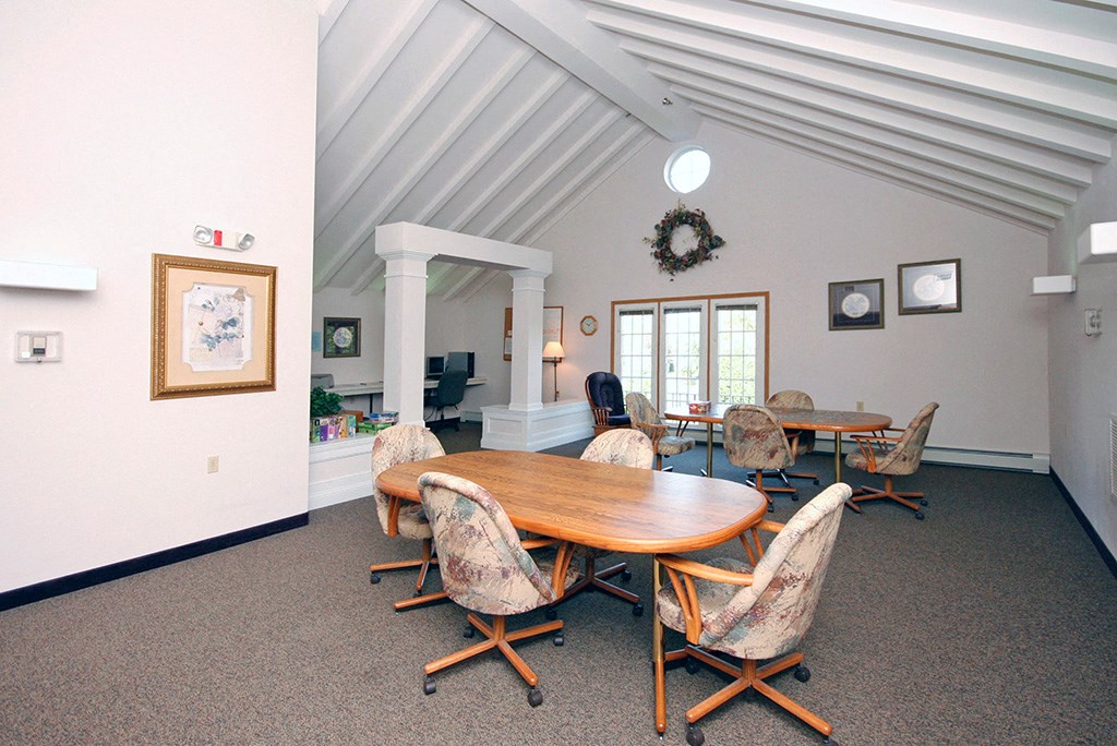 a conference room with a wooden table and chairs