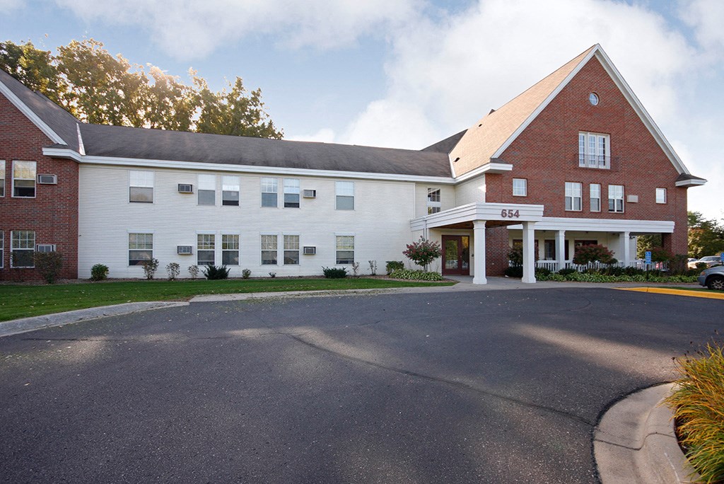 a large white building with a road in front of it