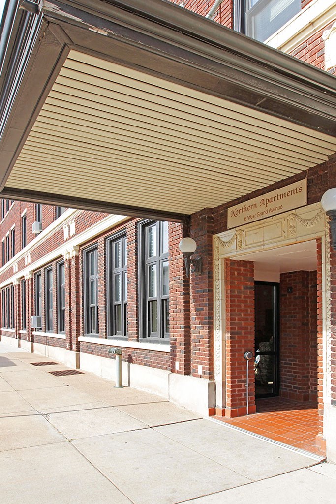 a brick building with awning over the sidewalk