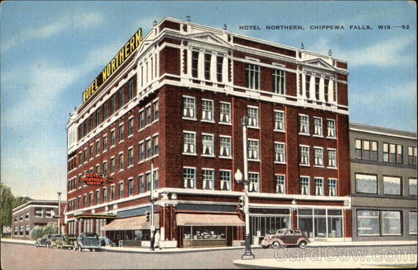 an old picture of a hotel on the corner of a street