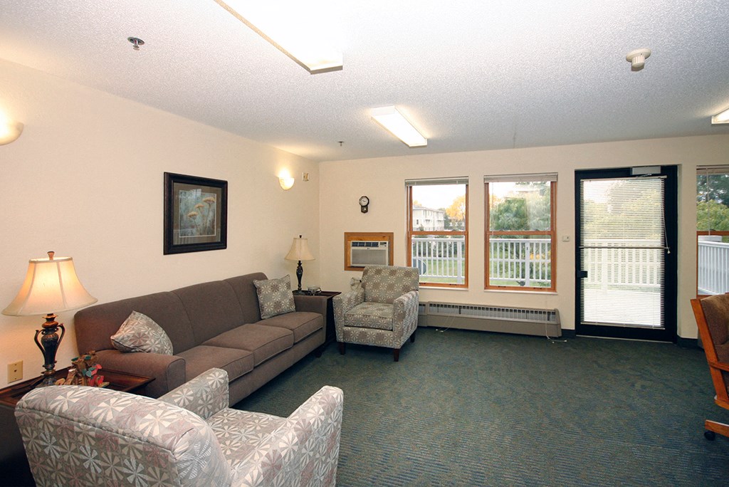 a living room with couches and chairs and a fireplace