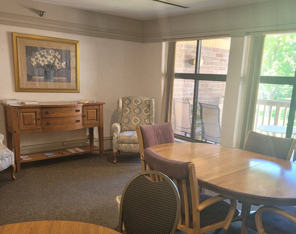 a dining room with a table and chairs and a window