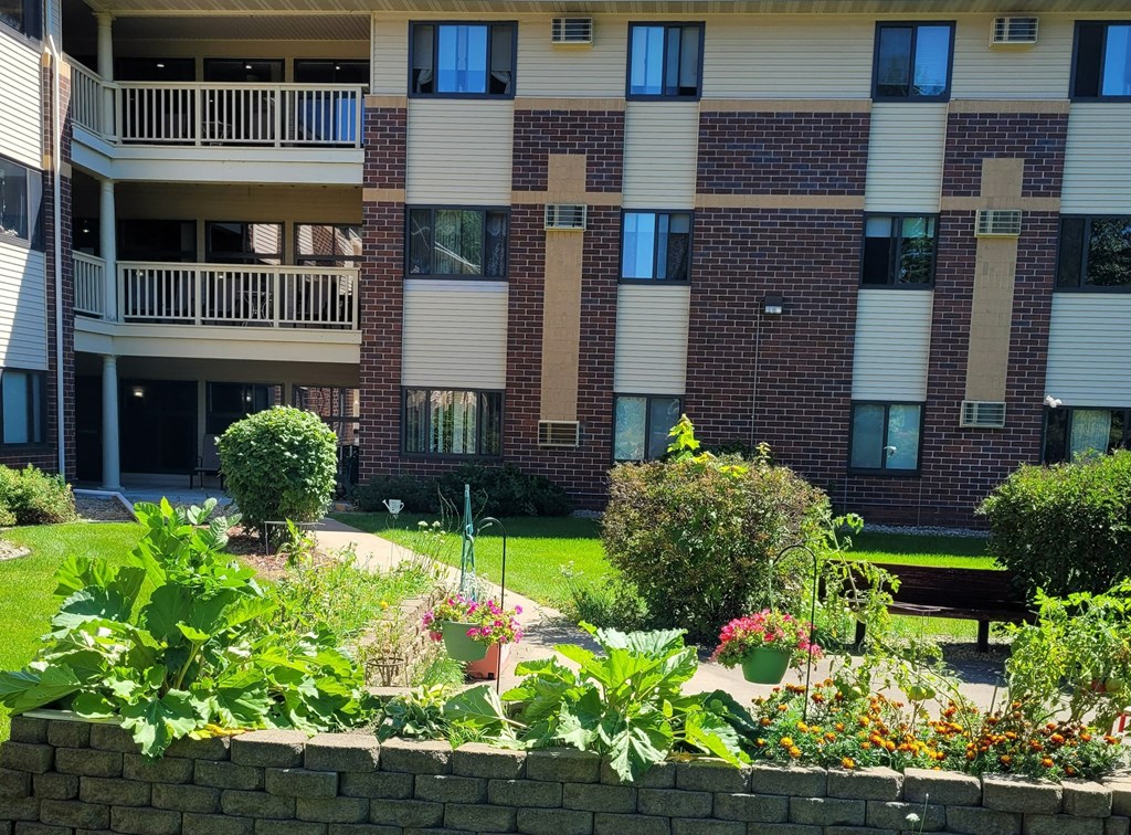 a garden in front of an apartment building