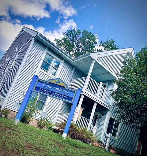 a blue building with a blue sign in front of it