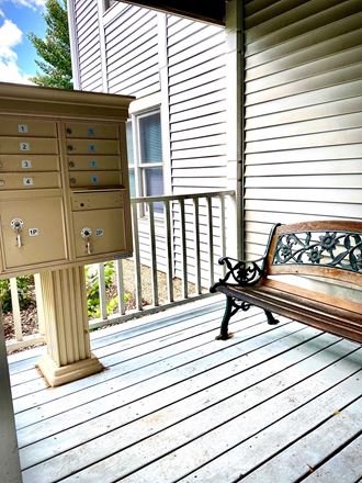 a bench and a dresser on a porch