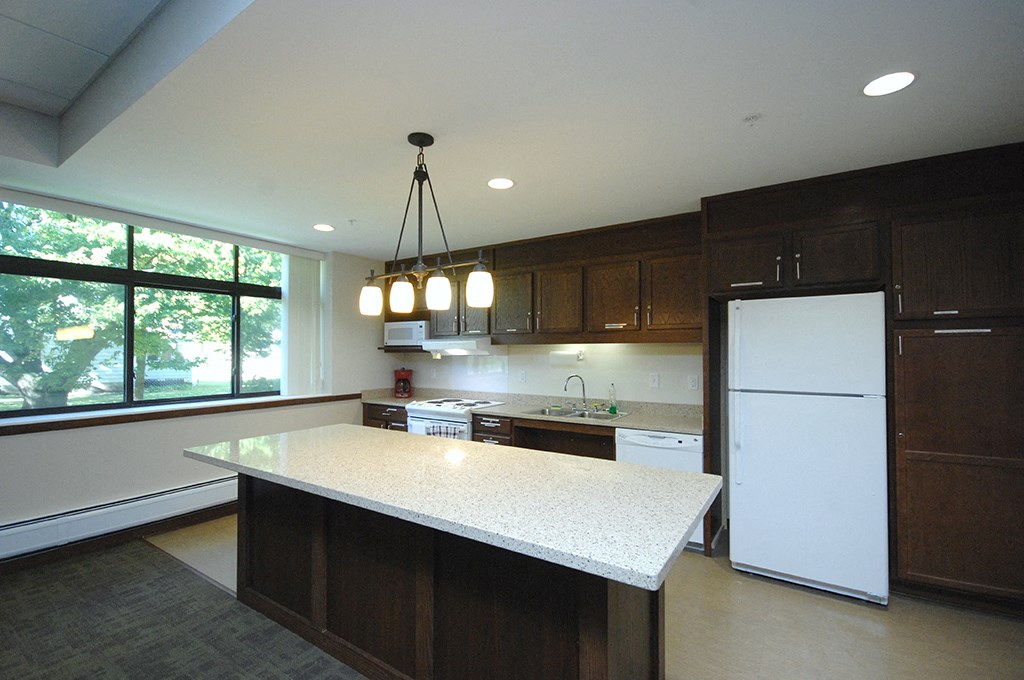 a kitchen with a large island and a refrigerator