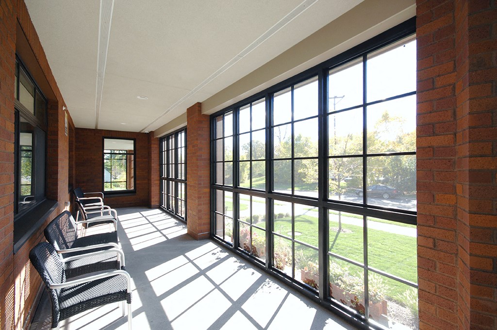 a room with large windows and chairs in front of it