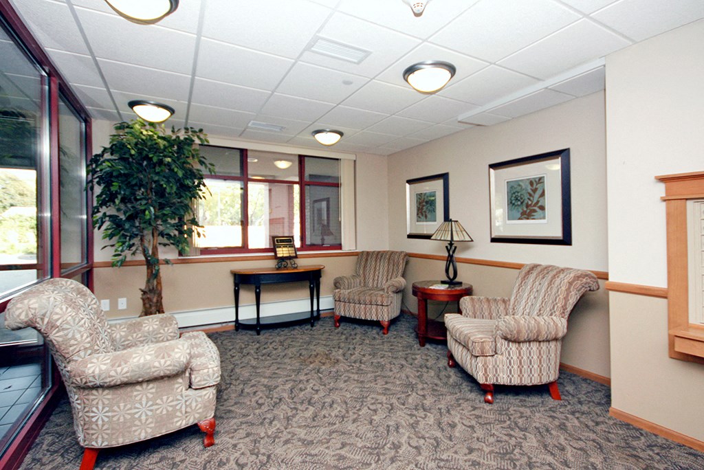 a waiting room with chairs and a table