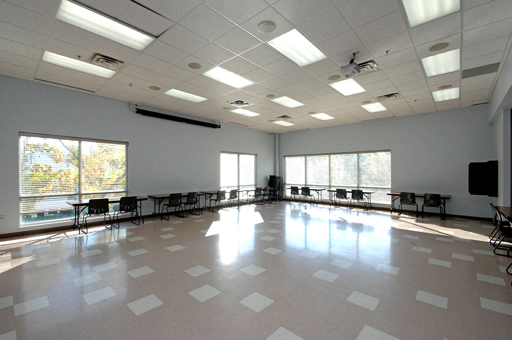 a large room with tables and chairs in it and a dance floor