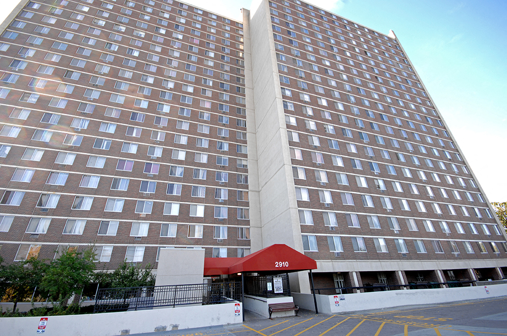 a tall building with a red roof in front of it