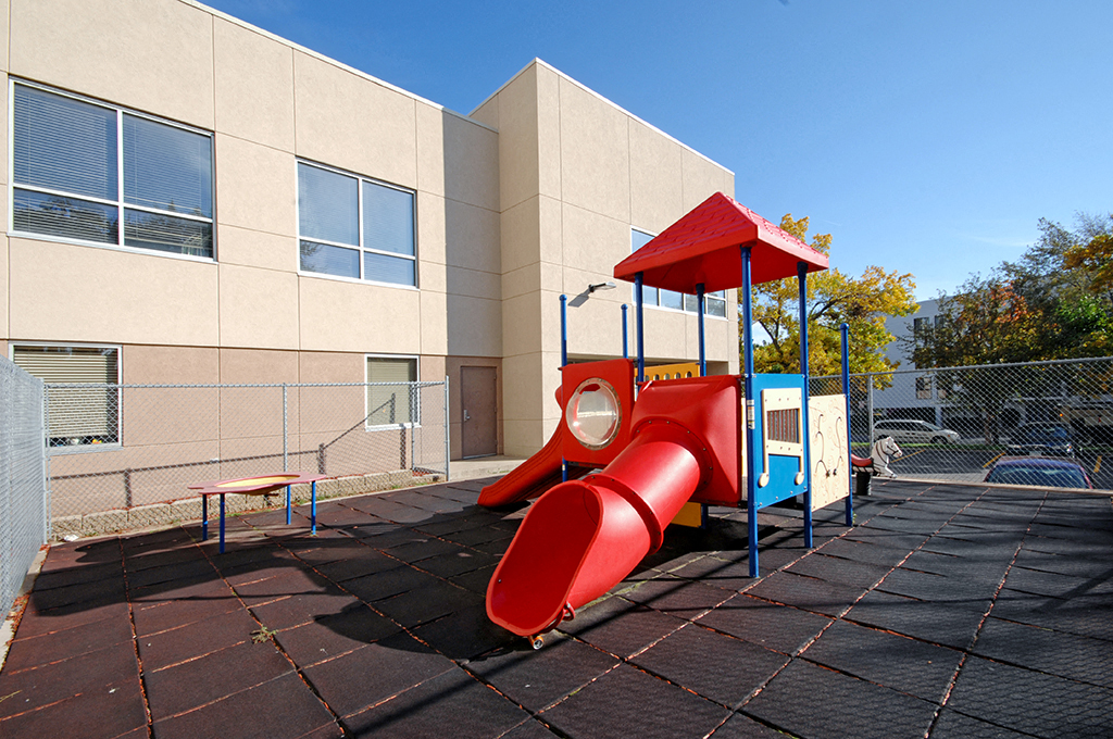 a childrens playground in front of a building