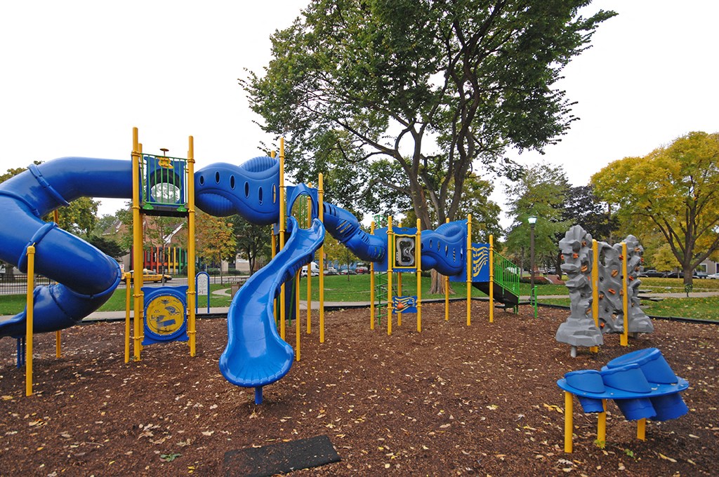 a playground with a blue slide and other playground equipment