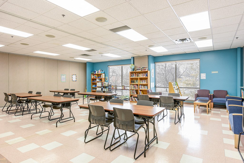 a dining room with tables and chairs in a library