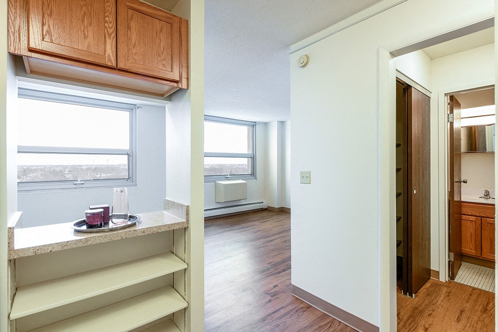 a view of a living room and a kitchen with a window