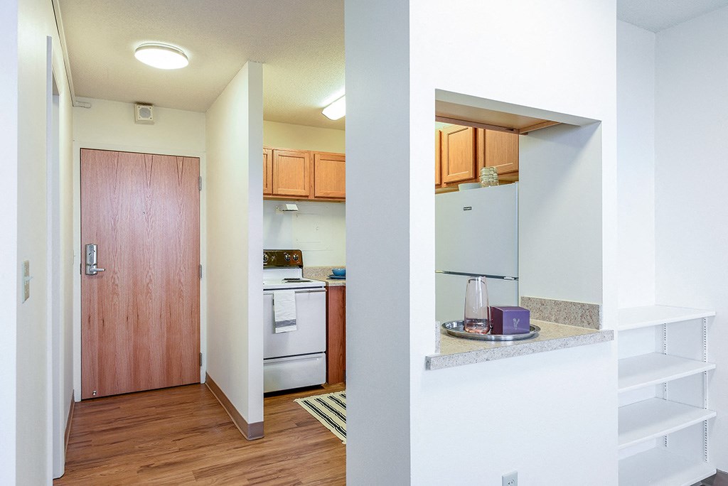 a view of a kitchen and a door into a living room