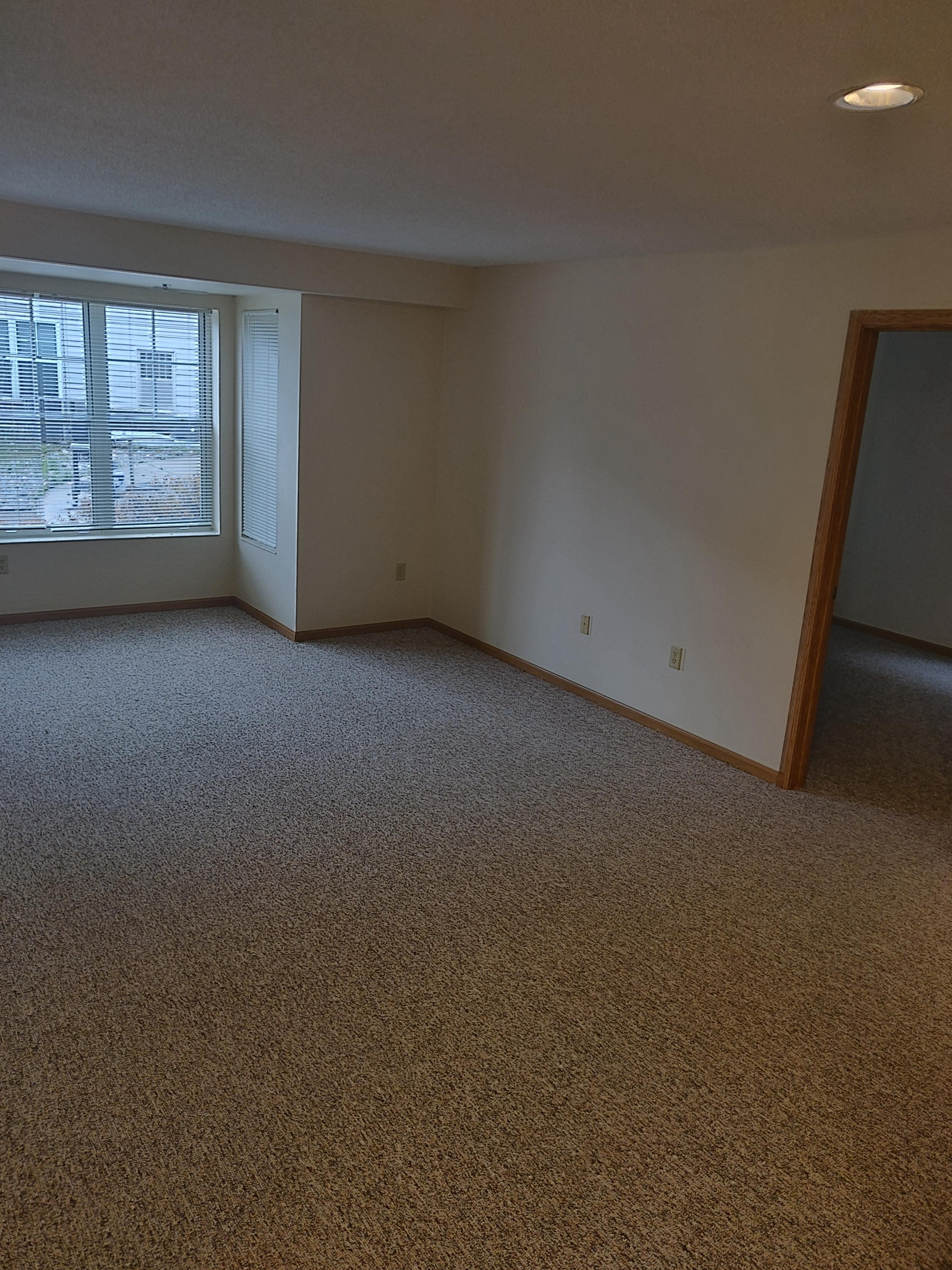 an empty living room with a large window