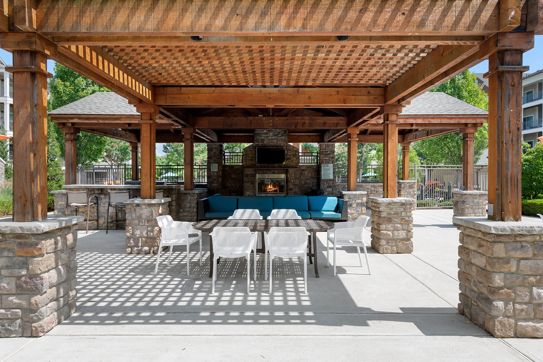 Outdoor grilling area seating at Atley on the Greenway Apartments in Ashburn VA