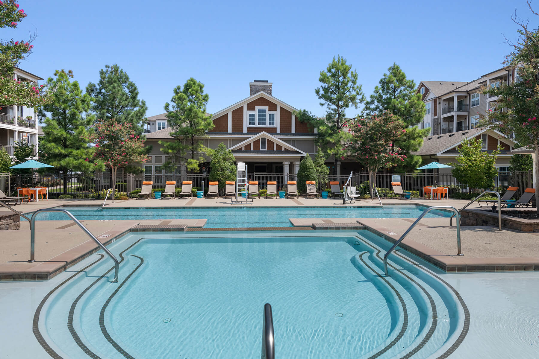 Large Swimming pool with deck chairs at Atley on the Greenway Apartments in Ashburn VA